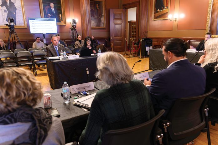 EARLY START: The Special Legislative Commission to Study Housing Affordability holds a hearing at the Statehouse in December, weeks ahead of the the 2026 legislative session. Testifying before the commission are Randy R. Rossi, left, Rhode Island League of Cities and Towns executive director, and Ashley Sweet, immediate past president of the Rhode Island Chapter of the American Planning ­Association. PBN PHOTO/MICHAEL SALERNO