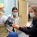 LEARNING ­OPPORTUNITY: Denise Coppa, center, University of Rhode Island College of Nursing professor and interim associate dean, supervises as nurse practitioner student Elizabeth Grieser, right, examines a patient at Rhode Island Hospital.  COURTESY ­UNIVERSITY OF RHODE ISLAND