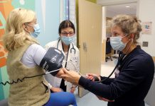 New federal student loan rules remove nursing’s ‘professional’ status reclassify nursing LEARNING OPPORTUNITY: Denise Coppa, center, University of Rhode Island College of Nursing professor and interim associate dean, supervises as nurse practitioner student Elizabeth Grieser, right, examines a patient at Rhode Island Hospital.
COURTESY UNIVERSITY OF RHODE ISLAND