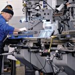 HANDIWORK: Tool maker Bobby Bianca operates a milling machine on the production floor at Warwick Hanger Co. in Westerly.  PBN PHOTO/MICHAEL SALERNO