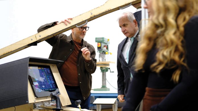 TEST SUBJECT: Justin Sirotin, left, co-founder of Octo Product Development Inc., shows U.S. Sen. Jack Reed a mockup of a cockpit used by Regent Craft Inc. at Octo’s design lab in Providence. Regent is developing 12-passenger seagliders at its North Kingstown headquarters.  COURTESY OCTO PRODUCT DEVELOPMENT INC.