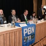KARL WADENSTEN, third from the left, CEO and president VIBCO Inc., speaks at the Providence Business News Workforce Development Summit on Thursday morning. Also on the first of two panels is, from left, Matthew Weldon, director of the R.I. Department of Labor and Training; Farouk Rajab, CEO and president of the Rhode Island Hospitality Association and the Rhode Island Hospitality Education Foundation; and Rosa Brito, workforce development manager for Brown University Health. PBN Editor Michael Mello, standing, moderated. PBN PHOTO/MIKE SKORSKI