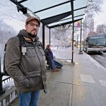 TIME CONSCIOUS: Barry Dejasu of East Providence waits at Kennedy Plaza to make his R.I. Public Transit Authority bus home after arriving on a bus from Warwick, where he works. RIPTA service changes have made his commute longer and more complex. PBN PHOTO/MICHAEL SALERNO