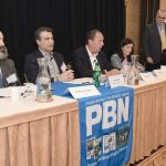 IN DEMAND: Karl Wadensten, center, CEO and president of VIBCO Inc. and R.I. Commerce Corp. board member, talks about the need for skilled workers during the first panel discussion of Providence Business News’ 2026 Workforce Development Summit at the Providence Marriott Downtown on Feb. 19. With Wadensten on the panel are, from left, Matthew Weldon, director of the R.I. Department of Labor and Training; Farouk Rajab, CEO and president of both the Rhode Island Hospitality Association and the Rhode Island Hospitality Education Foundation; and Rosa Brito, manager of workforce development at Brown University Health. PBN Editor Michael Mello, standing, moderates. PBN PHOTO/MIKE SKORSKI