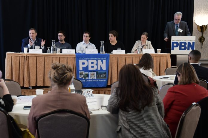 TED WILLIAMS, far left, president of Senesco Marine LLC, speaks during one of the panel discussions at Providence Business News' 2026 Emerging Industries Summit on Wednesday. Also on the panel is, from left, Ben Sorkin, CEO of Flux Marine Ltd.; Jason Noel, operations executive at Juice Robotics LLC; Linda Larsen, maritime and industry engagement manager at Polaris Tech Bridge; and Daniela Fairchild, chief strategy officer at R.I. Commerce Corp. PBN Editor Michael Mello, standing, is moderating. / PBN PHOTO/MIKE SKORSKI