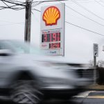 FUEL PRICES are displayed at a gas station as cars drive by last week in Baltimore, Md. Oil prices spiked near $120 per barrel Monday as the Iran war intensified, threatening production and shipping in the Middle East and pummeling financial markets. / AP PHOTO/STEPHANIE SCARBROUGH