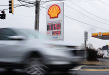 FUEL PRICES are displayed at a gas station as cars drive by last week in Baltimore, Md. Oil prices spiked near $120 per barrel Monday as the Iran war intensified, threatening production and shipping in the Middle East and pummeling financial markets. / AP PHOTO/STEPHANIE SCARBROUGH