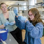 LAB WORK: Kaitlin Dailey, left, a University of Rhode Island assistant professor, monitors technician Victoria Coulter, a 2025 pharmaceutical sciences graduate, on URI’s South Kingstown campus.  PBN PHOTO/ MICHAEL SALERNO
