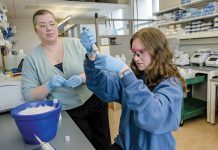 LAB WORK: Kaitlin Dailey, left, a University of Rhode Island assistant professor, monitors technician Victoria Coulter, a 2025 pharmaceutical sciences graduate, on URI’s South Kingstown campus.  PBN PHOTO/ MICHAEL SALERNO