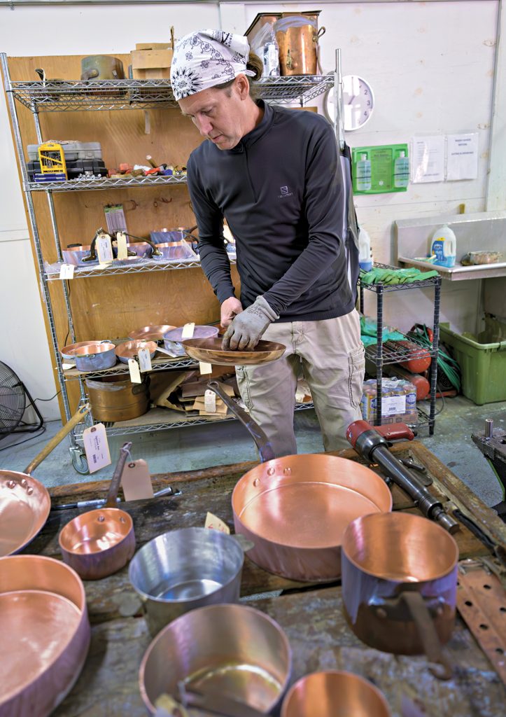 IT’S AN ART: Jim Hamann, owner and operator of Duparquet Copper Cookware in East Greenwich, puts the finishing touches on a pan.  PBN PHOTO/MICHAEL SALERNO