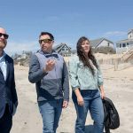 SITE ­INSPECTION: Jesse Reiblich, left, a University of Rhode Island professor in the marine affairs department, walks near the disputed property line along Roger W. Wheeler State Beach in Narragansett. He is joined, from left, by Nathan Vinhateiro, science director at the URI Coastal Institute, and Melva Trevino, assistant professor in URI’s fisheries, animal and veterinary sciences department.  PBN PHOTO/­ELIZABETH GRAHAM
