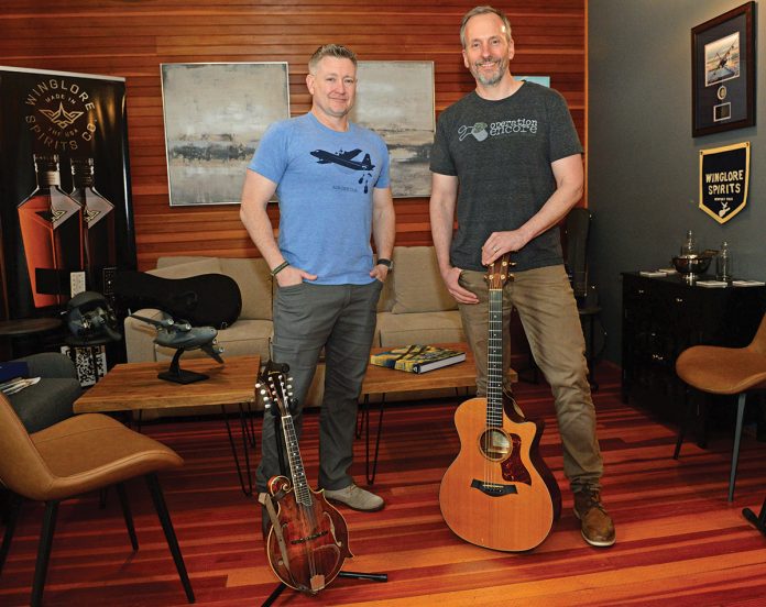 DYNAMIC DUO: Erik Brine, left, and Rob Raymond, co-founders of Operation Encore, at their office in Jamestown. The nonprofit provides opportunities for veteran and active-duty singer-songwriters and musicians to take their music to the next level, offering artist development, professional recording and educational services. PBN PHOTO/­ELIZABETH GRAHAM