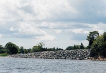 Should a North Kingstown country club be allowed to keep an unpermitted seawall it claims is protection against rising sea levels?