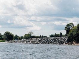 Should a North Kingstown country club be allowed to keep an unpermitted seawall it claims is protection against rising sea levels?