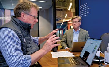 MEETING OF MINDS: Bob Chatman, left, Slater Technology Fund director, discusses the fund’s portfolio with Thorne Sparkman, Slater’s managing director, at the CIC Providence LLC building, the location of several companies that Slater has invested in.  PBN PHOTO/MICHAEL SALERNO