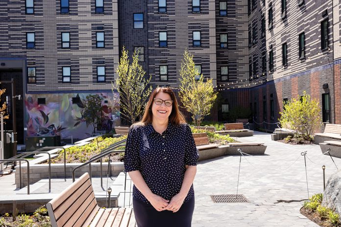 Raising the roof: Michelle Wilcox, CEO of Crossroads Rhode Island, was recognized for her work with the 2026 Women Leading the Way award by U.S. Rep. Seth Magaziner, D-R.I.  PBN PHOTO/­TRACY JENKINS