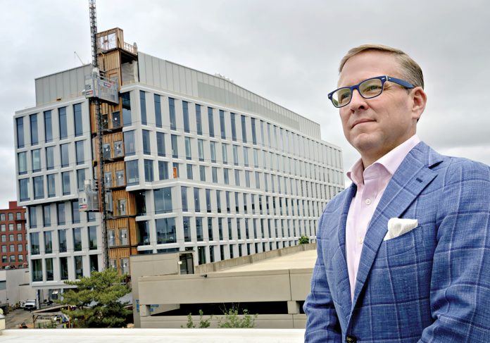 CHANGING MARKET: Leeds M­itchell IV, principal broker and partner at MG Commercial Real Estate, says the post-pandemic Providence office market is smaller but stable. Behind him is Brown University’s 300,000-square-foot integrated life sciences research facility.  PBN FILE PHOTO/­MICHAEL SALERNO