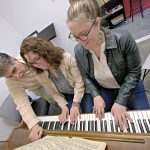 TICKLING THE IVORIES: Rebekah Zabinski, center, and Esther Zabinski, right, music teachers and owners of Zabinski Music School in Pawtucket, work with Guy Marini, who has been studying for two to five years and is now writing his own music. PBN PHOTO/MICHAEL SALERNO
