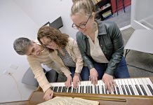TICKLING THE IVORIES: Rebekah Zabinski, center, and Esther Zabinski, right, music teachers and owners of Zabinski Music School in Pawtucket, work with Guy Marini, who has been studying for two to five years and is now writing his own music. PBN PHOTO/MICHAEL SALERNO