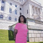 GIVING VOICE: Ann Clanton, founder and owner of Ann Clanton Communications, is pictured in front of the R.I. Statehouse. PBN PHOTO/MICHAEL SALERNO