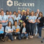 Giving time: Beacon Mutual  Insurance employees get  together to perform a  community service project. COURTESY THE BEACON MUTUAL INSURANCE CO.