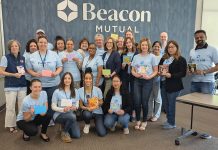 Giving time: Beacon Mutual  Insurance employees get  together to perform a  community service project. COURTESY THE BEACON MUTUAL INSURANCE CO.
