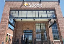 NEW WORKSPACE: Peter Gillespie, senior vice president and branch manager for Cross Insurance Inc., stands at the entrance of the company’s new offices at The Foundry in Providence.  PBN PHOTO/MATTHEW MCNULTY