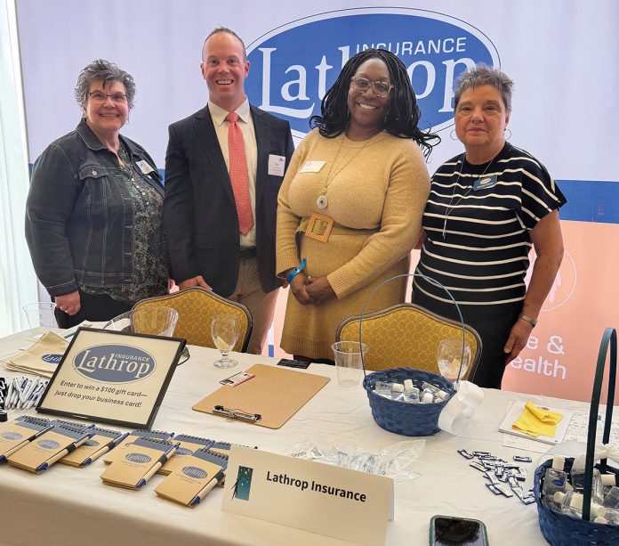 Motivated teaM: Lathrop Insurance employees at a professional event.
COURTESY LATHROP INSURANCE INC. Motivated teaM: Lathrop Insurance employees at a professional event.
COURTESY LATHROP INSURANCE INC.
