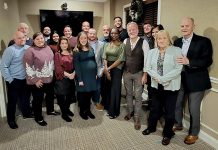 Getting in the spirit: Technology Advisory Group employees gather for a little bit of holiday cheer.  COURTESY TECHNOLOGY ADVISORS GROUP LLC