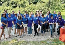 DRESSING THE PART: USI Insurance Services employees don matching T-shirts when regularly volunteering with nonprofits as part of the USI Gives Back program. COURTESY USI INSURANCE SERVICES LLC