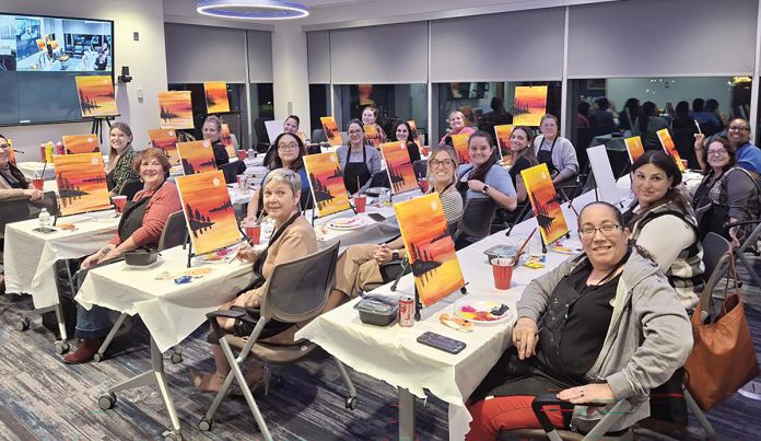 Paint the town orange: University Orthopedic employees participate in a company paint night.
COURTESY UNIVERSITY ORTHOPEDICS INC. Paint the town orange: University Orthopedic employees participate in a company paint night.
COURTESY UNIVERSITY ORTHOPEDICS INC.