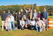 Shovel ready: Igus employees are out in force for an outdoor community service project.  COURTESY IGUS INC.