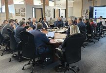 FULL HOUSE: Gov. Daniel J. McKee, third from the left, leads a June meeting of the R.I. Commerce Corp. board, whose 12 members are appointed by the governor.  COURTESY R.I. ­COMMERCE CORP.