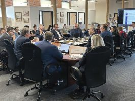 FULL HOUSE: Gov. Daniel J. McKee, third from the left, leads a June meeting of the R.I. Commerce Corp. board, whose 12 members are appointed by the governor.  COURTESY R.I. ­COMMERCE CORP.