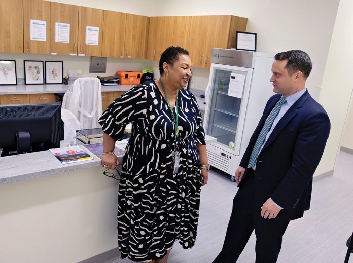 A MEDICAL CONSULTATION: Frances DaLomba, clinical director of the health and wellness center at the nonprofit Justice Assistance, chats with the organization’s CEO, Jacob Bissaillon.  PBN PHOTO/­MICHAEL SALERNO