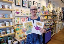 JOYFUL SURVIVAL: Kim T. Clark shows off some of the wares in her Rhody Craft gift shop in Providence, which she started as a pop-up in 2008 to support her children after she was treated for cancer and while going through a divorce.  PBN PHOTO/MICHAEL SALERNO