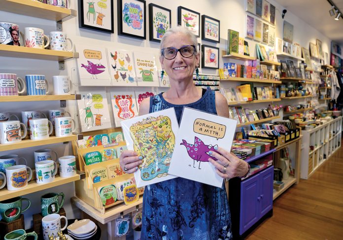 JOYFUL SURVIVAL: Kim T. Clark shows off some of the wares in her Rhody Craft gift shop in Providence, which she started as a pop-up in 2008 to support her children after she was treated for cancer and while going through a divorce.
PBN PHOTO/MICHAEL SALERNO JOYFUL SURVIVAL: Kim T. Clark shows off some of the wares in her Rhody Craft gift shop in Providence, which she started as a pop-up in 2008 to support her children after she was treated for cancer and while going through a divorce.
PBN PHOTO/MICHAEL SALERNO