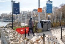 MORE OF THE SAME: Walkers heading south on the Newport Cliff Walk in 2023 are stopped at Narragansett Avenue by fencing because part of the historic walk collapsed in 2022. Little has changed since then. PBN FILE PHOTO/DAVID HANSEN