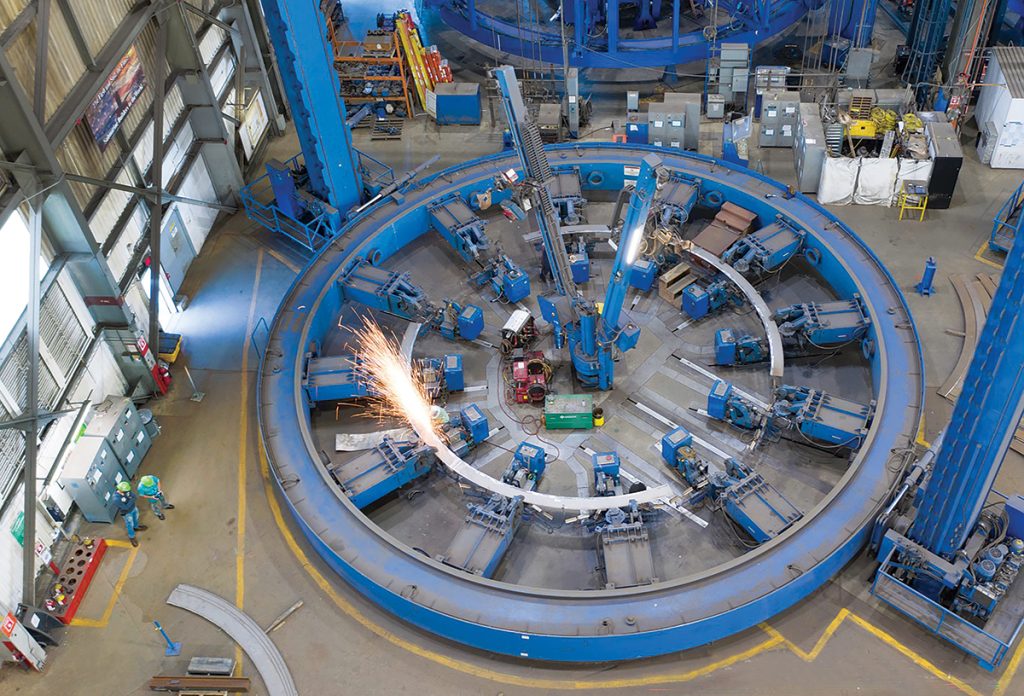 MAKING SPARKS FLY: ­Mechanics work in one of Electric Boat’s metal fabrication “fixtures” used to build frames that reinforce a submarine’s ­pressure hull.  COURTESY ­GENERAL  DYNAMICS ­ELECTRIC BOAT