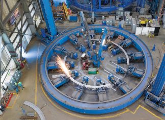 MAKING SPARKS FLY: ­Mechanics work in one of Electric Boat’s metal fabrication “fixtures” used to build frames that reinforce a submarine’s ­pressure hull.  COURTESY ­GENERAL  DYNAMICS ­ELECTRIC BOAT