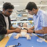 TEST BED: ­Abdullah al Rumon, left, and Dr. Kunal Mankodiya, director of the Wearable Biosensing Lab at the University of Rhode Island, are part of a team developing a smart strap that can monitor the health condition of premature babies. PBN PHOTO/­ELIZABETH ­GRAHAM
