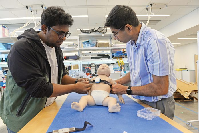 TEST BED: Abdullah al Rumon, left, and Dr. Kunal Mankodiya, director of the Wearable Biosensing Lab at the University of Rhode Island, are part of a team developing a smart strap that can monitor the health condition of premature babies.
PBN PHOTO/ELIZABETH GRAHAM TEST BED: Abdullah al Rumon, left, and Dr. Kunal Mankodiya, director of the Wearable Biosensing Lab at the University of Rhode Island, are part of a team developing a smart strap that can monitor the health condition of premature babies.
PBN PHOTO/ELIZABETH GRAHAM
