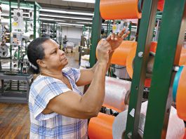 STRING SKILLS: ­Machine operator Maria Dacruz works on the production floor of Neocorp Inc., a standard and technical rope and bungee cord maker in Pawtucket. Neocorp was among the local manufacturers that dealt with inflated tariffs in 2025.  PBN FILE PHOTO/­MICHAEL SALERNO