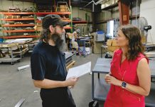 SHINING BRIGHT:  Rich Reynolds, left, fabrication supervisor, speaks with Jessica Mularski, majority owner, at Renova Lighting Systems Inc. in Warwick. PBN PHOTO/­MICHAEL SALERNO