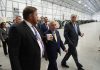 L3HARRIS TECHNOLOGIES INC. executives lead Sen. Sheldon Whitehouse, D-R.I., right, and Sen. Jack Reed, D-R.I., center, through its new 50,000-square-foot production facility at ProvPort. The new site will support the integration and testing of undersea training ranges for U.S. and partner-nation fleets, the company said. / COURTESY L3HARRIS TECHNOLOGIES INC.