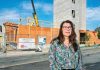 UNDER CONSTRUCTION: Michelle Wilcox, CEO and president of Crossroads Rhode Island, stands in front of the Summer Street Apartments project in Providence in 2024. It’s Crossroads’ five-story building featuring 176 single-bed residences for those who were previously homeless.  PBN FILE PHOTO/MICHAEL SALERNO
