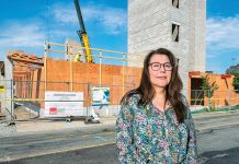 For homebuyers, landscape grows more discouraging UNDER CONSTRUCTION: Michelle Wilcox, CEO and president of Crossroads Rhode Island, stands in front of the Summer Street Apartments project in Providence in 2024. It’s Crossroads’ five-story building featuring 176 single-bed residences for those who were previously homeless.
PBN FILE PHOTO/MICHAEL SALERNO