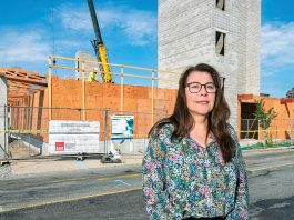 UNDER CONSTRUCTION: Michelle Wilcox, CEO and president of Crossroads Rhode Island, stands in front of the Summer Street Apartments project in Providence in 2024. It’s Crossroads’ five-story building featuring 176 single-bed residences for those who were previously homeless.  PBN FILE PHOTO/MICHAEL SALERNO