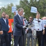 READY FOR BATTLE: Gov. Daniel J. McKee takes the podium as state and labor officials join forces in August 2025 to protest President Donald Trump’s effort to halt work on the Revolution Wind offshore wind farm.  PBN FILE PHOTO/MATTHEW MCNULTY