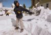 JESUS TORRES shovels out his Cranston driveway after a winter storm dumped about 3 feet of snow across Rhode Island from Feb. 22-23. Rhode Island’s congressional delegation is demanding answers as to why the Trump administration blocked disaster relief funding for the state. / AP FILE PHOTO/CHARLES KRUPA